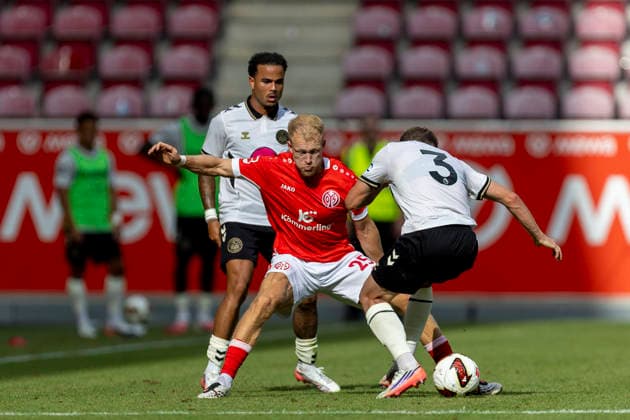 GER, Mainz, Soccer, Friendly Match, FSV Mainz 05 vs. AFC Bournemouth (pictured, from left): Andreas Hanche Olsen (FSV Mainz 05, 25), Adrien Truffert, AFC Bournemouth 03, tackle, August 15, 2026, MEWA Arena, Mainz. DFL and DFB regulations prohibit any use of photographs as image sequences and or quasi-video, Copyright: HMBxMedia PaulxFritz