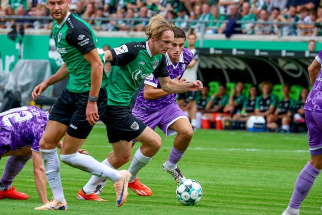August 15, 2026, xsscx, Soccer 3rd Division, Preußen Münster vs. FC Ingolstadt 04, Matchday 2, LVM Preußenstadion, 2026–2027 Season: Ryan Johansson of SC Preußen Münster 20 in a tackle against Emre Gül of FC Ingolstadt 5. DFB regulations prohibit any use of photographs as image sequences and or quasi-video. North Rhine-Westphalia, Germany
