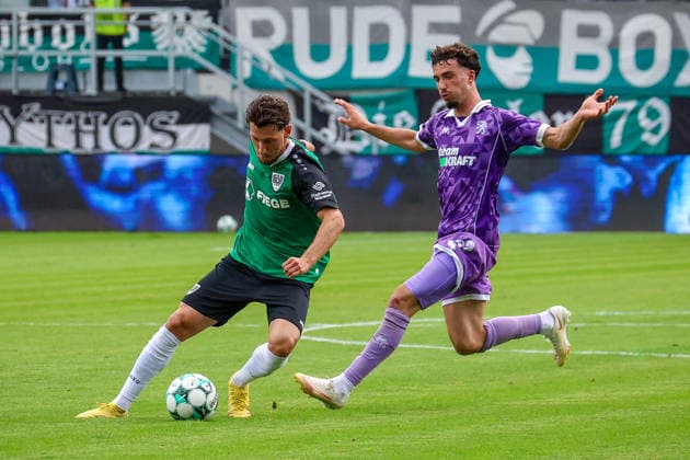 August 15, 2026, xsscx, Soccer 3rd Division, Preußen Münster vs. FC Ingolstadt 04, Matchday 2, LVM Preußenstadion, 2026–2027 Season: Charalambos Makridis of SC Preußen Münster 14 in a tackle against Davide Danilo Sekulovic of FC Ingolstadt 33. DFB regulations prohibit any use of photographs as image sequences and or quasi-video. North Rhine-Westphalia, Germany