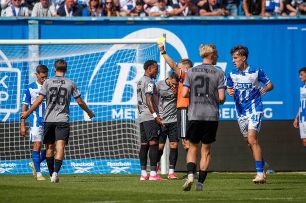 Referee Felix Weller shows Leroy Mickels of Waldhof a yellow card GER, FC Hansa Rostock vs. SV Waldhof Mannheim, Soccer, Men, 3rd Division, Matchday 2, 2026–2027 Season, August 16, 2026, Rostock Ostseestadion, Mecklenburg-Western Pomerania, Germany