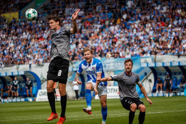 from left: Maximilian Thalhammer (Waldhof), Andreas Voglsammer (Rostock), and Lukas Klünter (Waldhof) GER, FC Hansa Rostock vs. SV Waldhof Mannheim, Soccer, Men, 3rd Division, Matchday 2, 2026–2027 Season, August 16, 2026, Rostock Ostseestadion, Mecklenburg-Western Pomerania, Germany