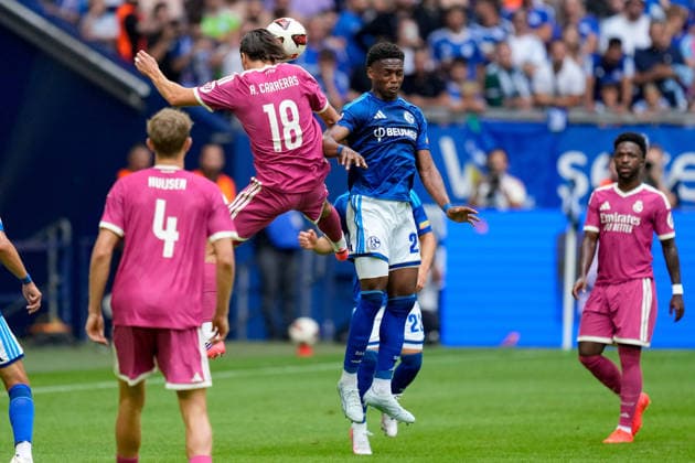 Alvaro Carreras of Real Madrid CF and Junior Adamu of FC Schalke 04 battle for the ball during the preseason friendly match between FC Schalke 04 and Real Madrid at Veltins Arena on August 16, 2026, in Gelsenkirchen, Germany. Photo by Alex Gottschalk, DeFodi Images