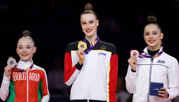 Medal Ceremony for the Ribbon Final at the 2026 Rhythmic Gymnastics World Championships in Frankfurt am Main, Germany, on August 16, 2026: from left, Stiljana Nikolova of Bulgaria (silver), Darja Varfolomeev of Germany (gold), and Sofija Ilterjakova, a neutral athlete, bronze, with their medals. Medal ceremony for the ribbon final at the 2026 Rhythmic Gymnastics World Championships in Frankfurt am Main, Germany, on August 16, 2026; from left to right: Stiliana Nikolova (Bulgaria), silver; Darja Varfolomeev (Germany), gold; and Sofija Ilterjakowa (Individual Neutral Athlete), bronze, with their medals Copyright: HMBxMedia xHeikoxBecker