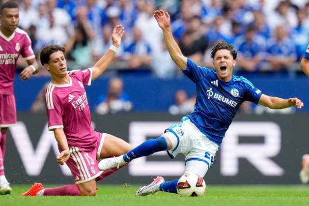 Arda Gueler of Real Madrid CF and Soufiane El Faouzi of FC Schalke 04 battle for the ball during the preseason friendly match between FC Schalke 04 and Real Madrid at Veltins Arena on August 16, 2026, in Gelsenkirchen, Germany. Photo by Alex Gottschalk, DeFodi Images