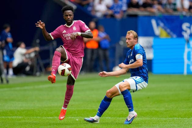Vinicius Junior of Real Madrid CF and Timo Becker of FC Schalke 04 battle for the ball during the preseason friendly match between FC Schalke 04 and Real Madrid at Veltins Arena on August 16, 2026, in Gelsenkirchen, Germany. Photo by Alex Gottschalk, DeFodi Images