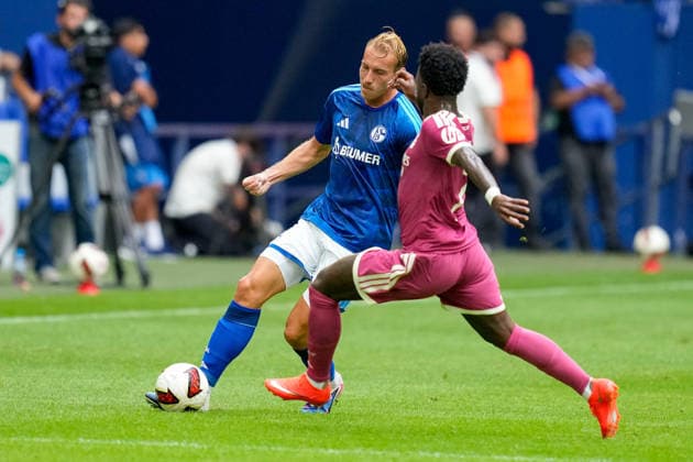 Timo Becker of FC Schalke 04 and Vinicius Junior of Real Madrid CF battle for the ball during the preseason friendly match between FC Schalke 04 and Real Madrid at Veltins Arena on August 16, 2026, in Gelsenkirchen, Germany. Photo by Alex Gottschalk, DeFodi Images