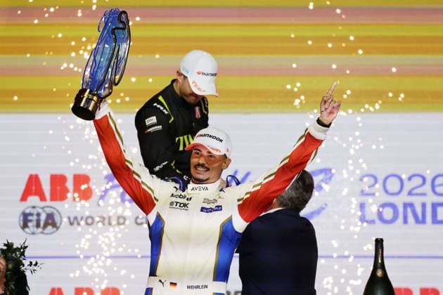 World Champion Pascal Wehrlein (GER) of Porsche poses on the podium with the World Championship trophy, FIA Formula E World Championship, Season 12, London E-Prix, August 16, 2026, Excel Exhibition Center, Race 2