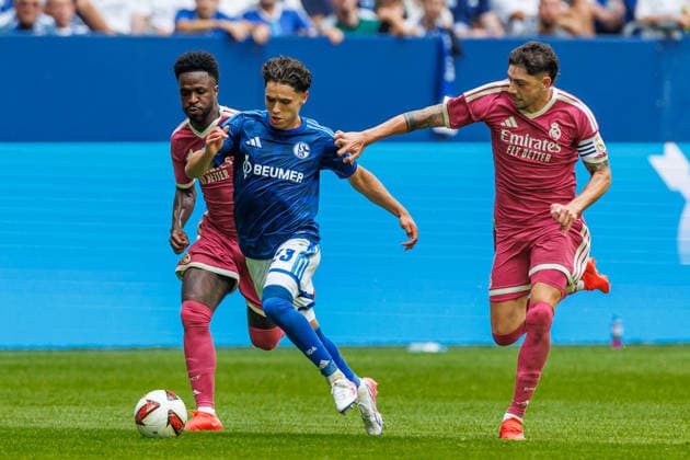 Vinicius Junior of Real Madrid CF, Soufiane El Faouzi of FC Schalke 04, and Federico Valverde of Real Madrid CF battle for the ball during the preseason friendly match between FC Schalke 04 and Real Madrid at Veltins Arena on August 16, 2026 in Gelsenkirchen, Germany. Photo by Mario Hommes, DeFodi Images