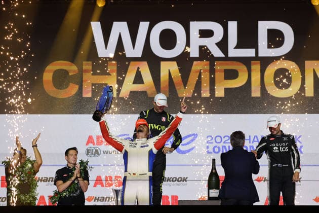 Jake Dennis (GBR), second place; World Champion Pascal Wehrlein (GER) in a Porsche, posing with the World Championship trophy; and Mitch Evans, third in the World Championship, on the podium; FIA Formula E World Championship, Season 12, London E-Prix, August 16, 2026, Excel Exhibition Center, Race 2