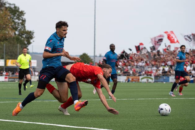 KERZERS, FRIBOURG, SWITZERLAND - AUGUST 16: Donat Rudhani of FC Sion holds back Enea Rostetter of FC Kerzers during the Swiss Cup first round match between FC Kerzers and FC Sion at Stadion Erli on August 16, 2026 in Kerzers, Fribourg, Switzerland. Copyright: xLivioxBaeriswylx xSPPx Sportspressphoto_SPR208873