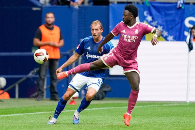Timo Becker of FC Schalke 04 and Vinicius Junior of Real Madrid CF battle for the ball during the preseason friendly match between FC Schalke 04 and Real Madrid at Veltins Arena on August 16, 2026, in Gelsenkirchen, Germany. Photo by Alex Gottschalk, DeFodi Images