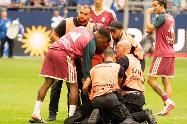 August 16, 2026: Soccer – FC Schalke 04 vs. Real Madrid, friendly match at the Veltins Arena in Gelsenkirchen. A Real Madrid fan runs onto the field after the kickoff to take a selfie with Kylian Mbappé of Real Madrid, 10 and is intercepted by security after the selfie and escorted off the field IMPORTANT NOTICE In accordance with the guidelines of the DFL and the DFB, it is prohibited to to use or allow the use of photographs taken in the stadium and or during the game in the form of sequential images and or video-like photo series Copyright: xJamesxZabelx