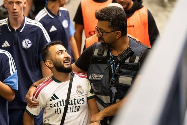 August 16, 2026: Soccer – FC Schalke 04 vs. Real Madrid, friendly match at the Veltins Arena in Gelsenkirchen. A Real Madrid fan runs onto the field after the kickoff to take a selfie with Kylian Mbappé of Real Madrid, 10 and is intercepted by security after the selfie and escorted off the field IMPORTANT NOTICE In accordance with the guidelines of the DFL and the DFB, it is prohibited to to use or allow the use of photographs taken in the stadium and or during the game in the form of sequential images and or video-like photo series Copyright: xJamesxZabelx
