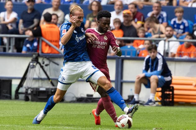 Gelsenkirchen, Germany, August 16, 2026, Timo Becker of FC Schalke 04 and Vinicius Junior of Real Madrid in a duel during the friendly match between FC Schalke 04 and Real Madrid at the Veltins Arena in Gelsenkirchen. Photo by Joachim Bywaletz. DFB and DFL regulations prohibit any use of photographs as IMAGE SEQUENCES AND OR QUASI-VIDEO Copyright: JoachimxBywaletz xJB-Sportfoto