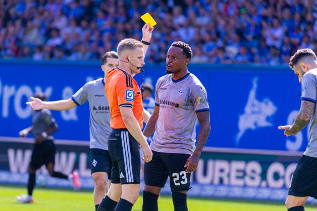 German 3rd Division, 2026–2027 Season, August 16, 2026, Matchday 2, FC Hansa Rostock vs. Waldhof Mannheim, Ostseestadion Weller, Referee Felix issues a yellow card to Mickels, Leroy (Waldhof Mannheim), 23 Copyright: xMichellexLukax