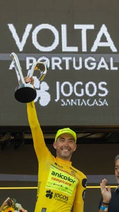 87th Volta A Portugal - 10th Stage French cyclist Alexis Guerin of Anicolor Campicarn celebrates on the podium after winning the general classification of the 87th Volta a Portugal, following the final stage from Maia to Porto, Portugal, on August 16, 2026. Porto Portugal  Copyright: xEduardoxAlmeidax originalFilename:almeida-notitle260816_npil9