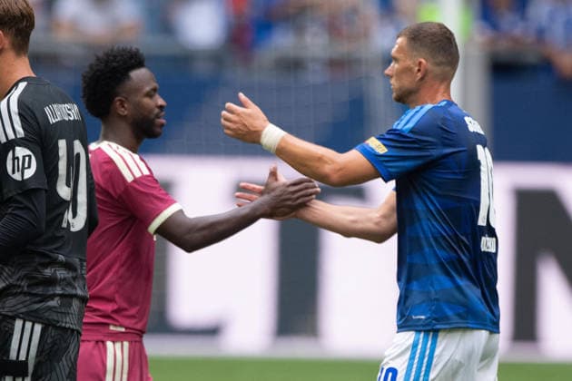 Vinicius JUNIOR of Real Madrid and Edin DZEKO of GE shake hands after the game, Soccer friendly match: FC Schalke 04 vs. Real Madrid 0–3 on August 16, 2026, at the Veltins Arena in Gelsenkirchen, Germany. DFL regulations prohibit any use of photographs as image sequences and or quasi-video.
