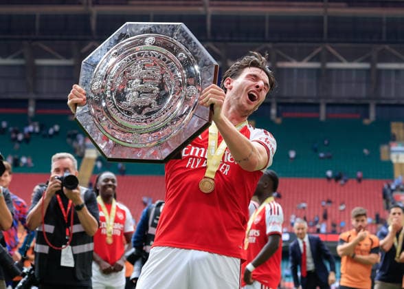 Cardiff, Wales, 16th August 2026. Declan Rice of Arsenal is hit in the face as he lifts the FA Community Shield trophy following the Arsenal vs Manchester City FA Community Shield match at Principality Stadium, Cardiff. Picture credit should read: Cody Froggatt Sportimage EDITORIAL USE ONLY. No use with unauthorised audio, video, data, fixture lists, club league logos or live services. Online in-match use limited to 120 images, no video emulation. No use in betting, games or single club league player publications. SPI_246_CF_ARSENAL_V_MANCHESTER_CITY SPI-4912-0246
