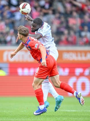 Yannik Wagner of 1 FC Heidenheim 1846 and Dayot Upamecano of FC Bayern Munich battle for the ball during the preseason friendly match between 1 FC Heidenheim and FC Bayern Munich at Voith Arena on August 18, 2026 in Heidenheim, Germany. Photo by Harry Langer, DeFodi Images