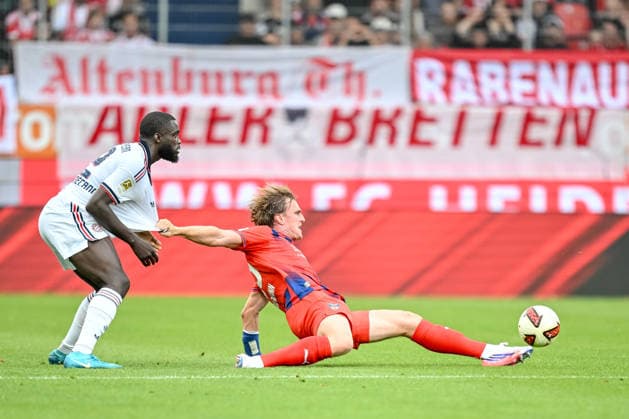 Dayot Upamecano of FC Bayern Munich and Mikkel Kaufmann of 1 FC Heidenheim 1846 battle for the ball during the preseason friendly match between 1 FC Heidenheim and FC Bayern Munich at the Voith Arena on August 18, 2026 in Heidenheim, Germany. Photo by Harry Langer, DeFodi Images