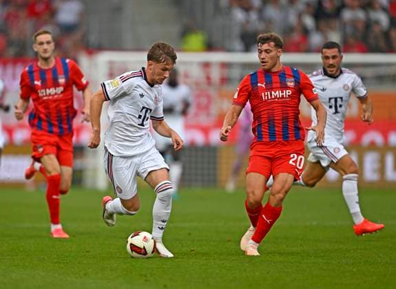 August 18, 2026, 2026–2027 Bundesliga, Friendly Match, 1. FC Heidenheim vs. FC Bayern Munich, at the Voith Arena in Heidenheim; from left: Tim Binder (Bayern Munich) vs. Luca Kerber (1. FC Heidenheim 1846)
