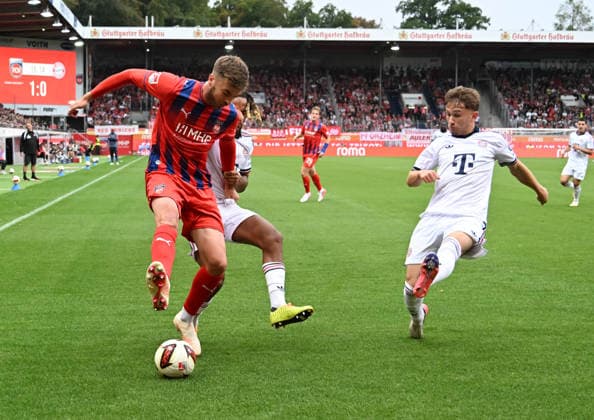 August 18, 2026, xsltx, soccer exhibition match, 1 FC Heidenheim vs. FC Bayern Munich – Julian Niehues (1 FC Heidenheim 1846), Sacha Boey (FC Bayern Munich), and Tim Binder (FC Bayern Munich). DFL and DFB regulations prohibit any use of photographs as image sequences and or quasi-video.