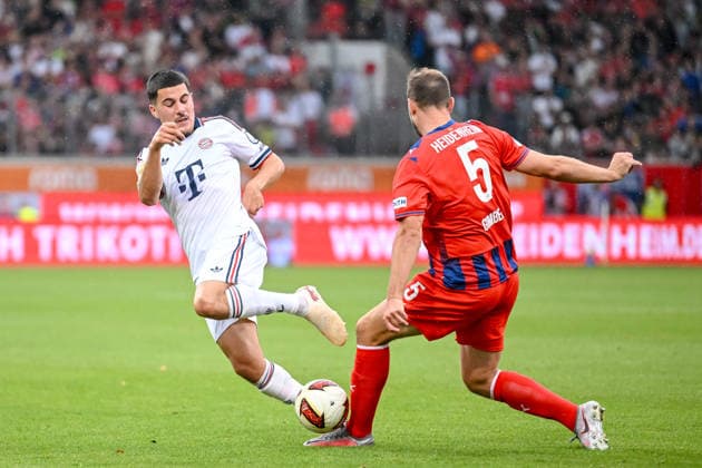 Felioe Chavez of FC Bayern Munich and Benedikt Gimber of 1 FC Heidenheim 1846 battle for the ball during the preseason friendly match between 1 FC Heidenheim and FC Bayern Munich at Voith Arena on August 18, 2026 in Heidenheim, Germany. Photo by Harry Langer, DeFodi Images