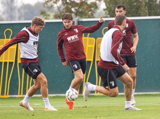 Mads Pedersen, FC Augsburg 3, center, passes the ball; Kristijan Jakic, FC Augsburg 17, left; Jeffrey Gouweleeuw, FC Augsburg 6, right; FC Augsburg, practice,