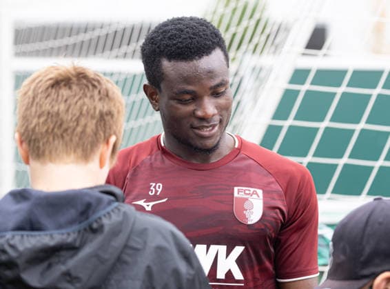 Uchenna Ogundu of FC Augsburg 39 signs autographs for young fans after practice FC Augsburg, Practice,