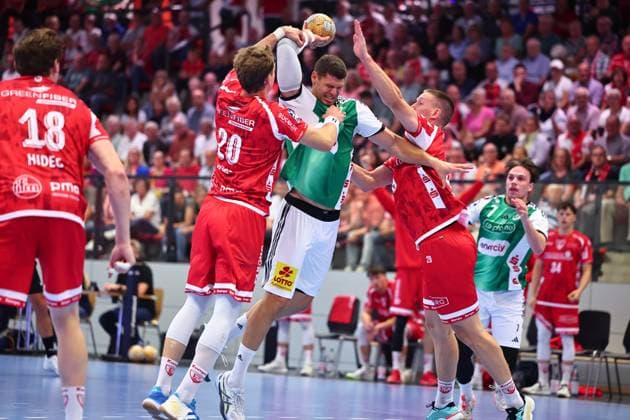 Sebastian Heymann (TSV Hannover Burgdorf), No. 11, in a one-on-one battle with Philip Wuerz (TuS Ferndorf), No. 20, on the left, and Fabian Hecker (TuS Ferndorf), No. 29, GER, TuS Ferndorf vs. TSV Hannover Burgdorf, Handball, DHB Cup, Round 1, 2026–2027 season, August 21, 2026, Germany, TuS Ferndorf vs. TSV Hannover Burgdorf, Handball, DHB Cup, 1st Round, 2026–2027 season, August 21, 2026, Kreuztal Copyright: xEibner-Pressefoto RenexWeissx EP_RWS