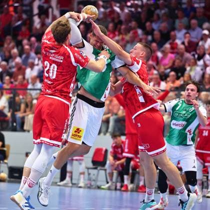 Sebastian Heymann (TSV Hannover Burgdorf), No. 11, in a one-on-one battle with Philip Wuerz (TuS Ferndorf), No. 20, on the left, and Fabian Hecker (TuS Ferndorf), No. 29 (GER), TuS Ferndorf vs. TSV Hannover Burgdorf, Handball, DHB Cup, Round 1, 2026–2027 season, August 21, 2026, Germany; TuS Ferndorf vs. TSV Hannover Burgdorf, Handball, DHB Cup, 1st Round, 2026–2027 season, August 21, 2026, Kreuztal Copyright: xEibner-Pressefoto RenexWeissx EP_RWS