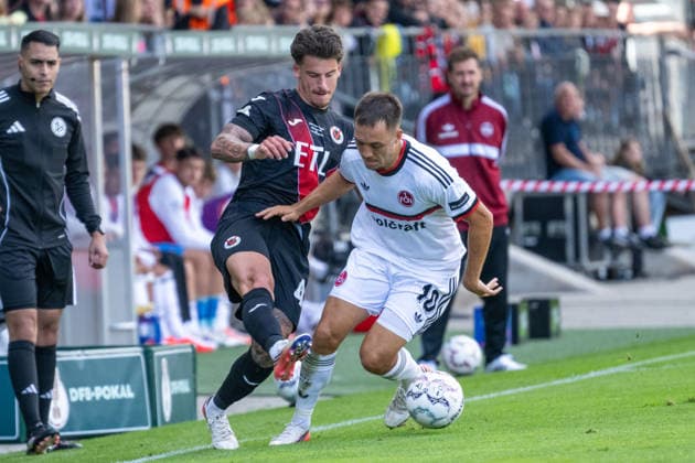 Tackle between Niklas Castelle of Viktoria Cologne, 44, and Julian Justvan of 1. FC Nuremberg, 10; Viktoria Cologne vs. 1. FC Nuremberg, Soccer, DFB Cup, 1st Round, 2026–2027 Season, August 22, 2026. DFL and DFB regulations prohibit any use of photographs as image sequences and or quasi-video. Viktoria Cologne vs. 1. FC Nuremberg, soccer, DFB Cup, Round 1, 2026–2027 season, August 22, 2026, Cologne Copyright: xEibner-Pressefoto ThomasxHaeslerx EP_THR