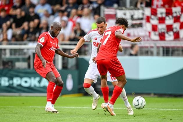 David Kinsombi of FC Würzburger Kickers, Said El Mala of 1. FC Köln, and Liam Omore of FC Würzburger Kickers in a tackle during the DFB Cup first-round match between Würzburger Kickers and 1. FC Köln, AKON ARENA on August 24, 2026, in Würzburg, Germany. Photo by Harry Langer, DeFodi Images. David Kinsombi of FC Würzburger Kickers, Said El Mala of 1. FC Köln and Liam Omore of FC Würzburger Kickers battle for the ball during the DFB Cup first-round match between FC Würzburger Kickers and 1. FC Köln at AKON ARENA on August 24, 2026 in Würzburg, Germany Photo by Harry Langer, DeFodi Images Photo by Harry Langer, DeFodi Images DFB and DFL regulations prohibit any use of photographs as image sequences and or quasi-video