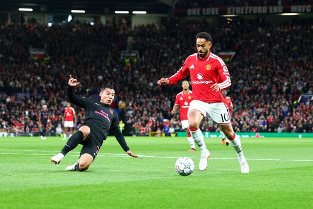 RECORD DATE NOT STATED 10th September 2026; Old Trafford, Manchester, England; UEFA Champions League Football, Manchester United, ManU versus Sabah; Matheus Cunha of Manchester United with Umarali Rakhmonaliev of Sabah FK sliding in RogerxEvans