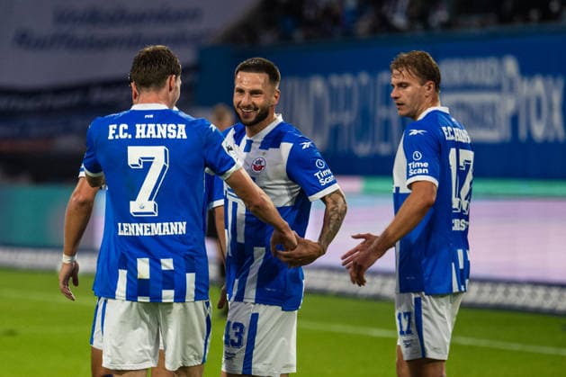 Rostock, Germany, September 16, 2026, 3. Liga 2026–2027, Matchday 6: FC Hansa Rostock vs. VfB Stuttgart II. Pictured, second from left: Leon Dajaku of Hansa Rostock celebrates after scoring the 1–0 goal with, from left, Bernie Lennemann of Hansa Rostock and Florian Carstens of Hansa Rostock. DFB and DFL regulations prohibit any use of photographs as image sequences and or quasi-video. Copyright: xFotostandx xVoelkerx