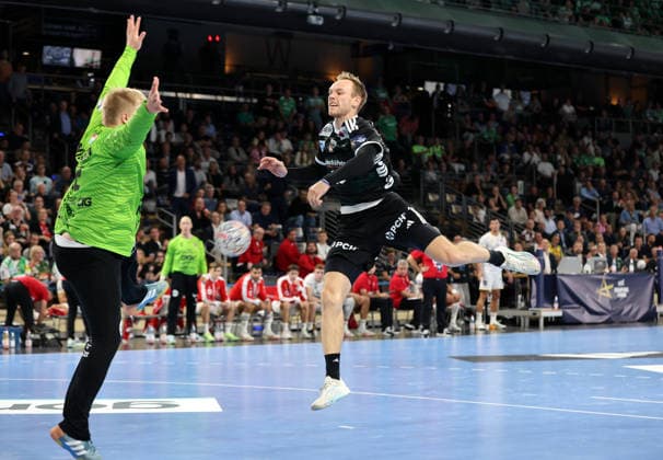 Mathias Gidsel scores a goal against goalkeeper Emil Nielsen; one-on-one, game action, sports, handball, Champions League, Men s Champions League, Matchday 2, 2026–2027 season, September 16, 2026, Füchse Berlin vs. One Veszprém HC at the Max Schmeling Hall