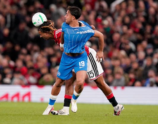 Manchester, England, 16th September 2026. Leny Yoro of Manchester United, ManU tussles with Charalampos Kostoulas of Brighton during the Manchester United vs Brighton and Hove Albion Carabao Cup match at Old Trafford, Manchester. Picture credit should read: Andrew Yates Sportimage EDITORIAL USE ONLY. No use with unauthorised audio, video, data, fixture lists, club league logos or live services. Online in-match use limited to 120 images, no video emulation. No use in betting, games or single club league player publications. SPI_027_AY_MAN_UTD_BRIGHTON SPI-5001-0028
