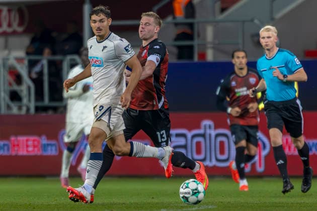 Ingolstadt, Germany, August 8, 2026, 3rd League 2026–2027, Matchday 6: FC Ingolstadt 04 vs. TSG Hoffenheim II. Pictured from left, in a tackle: Sean Dulic (TSG II) and Lars Lokotsch (FCI). DFB and DFL regulations prohibit any use of photographs as image sequences and or quasi-video. Audi Sportpark Bayern Copyright: xFotostandx xSchäferx