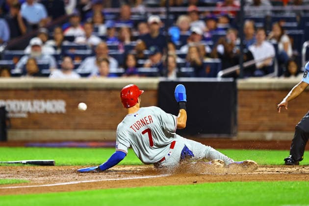 MLB, Baseball Herren, USA Philadelphia Phillies Vs. New York Mets Philadelphia Phillies Trea Turner 7 slides into home plate to score on a sacrifice fly during the seventh inning of a baseball game against the New York Mets at Citi Field in Corona, on September 17, 2026. Flushing N.Y. United States  Copyright: xGordonxDonovanx originalFilename:donovan-mlbphila260917_npqJT.jpg