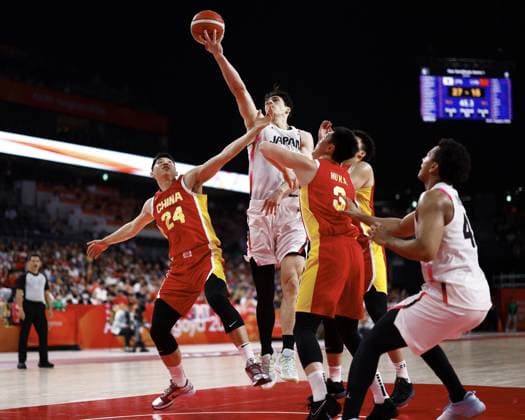 Aichi-Nagoya Asian Games: Basketball China s Cui Yongxi (24) and Hu Mingxuan (3) block Japan s Schafer Avi from shooting during the first quarter of a men s basketball semifinal match at the Aichi-Nagoya Asian Games at Aichi International Arena in Nagoya, central Japan, on Sept. 18, 2026.  A14AA0005627838P