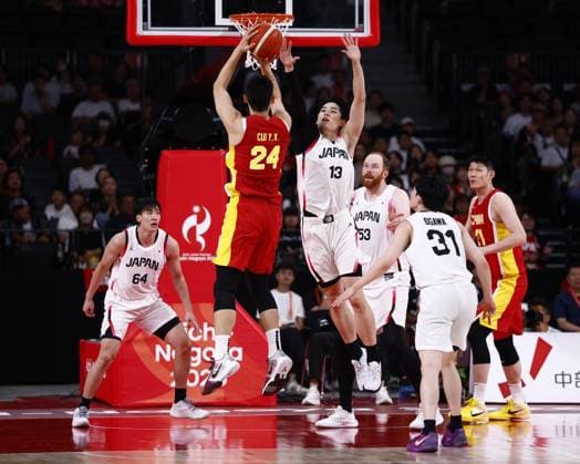 Aichi-Nagoya Asian Games: Basketball Japan s Ren Kanechika (13) blocks China s Cui Yongxi from shooting during the third quarter of a men s basketball semifinal match at the Aichi-Nagoya Asian Games at Aichi International Arena in Nagoya, central Japan, on Sept. 18, 2026.  A14AA0005627854P