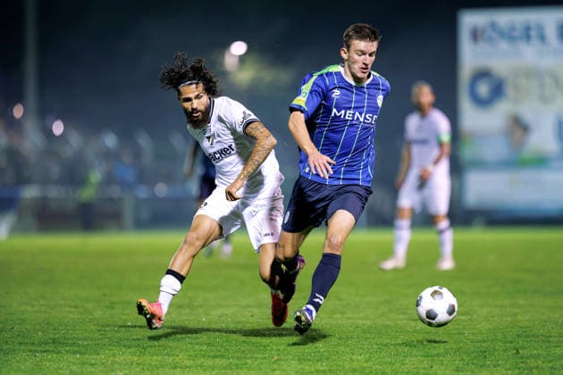 September 18, 2026, xkwix, Soccer, Regionalliga West, SV Rödinghausen vs. FC Gütersloh, Häcker Wiehenstadion, Matchday 9, 2026–2027 season: Aleksandar Kandic of FC Gütersloh 27 in a tackle against Mika Polat of SV Rödinghausen 8. DFB regulations prohibit any use of photographs as image sequences and or quasi-video. Photo: xKamilxWilkowskixPressefotoKochx, North Rhine-Westphalia, Germany