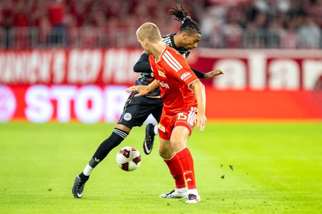 Michael Olise 17 (FC Bayern Munich) in a tackle with Tom Rothe 15 (1. FC Union Berlin), FC Bayern Munich vs. 1. FC Union Berlin, Bundesliga, Matchday 4, September 18, 2026. DFB regulations prohibit any use of photographs as image sequences and or quasi-video. Munich, Bayern, Germany Copyright: xkolbert-press UlrichxGamelx