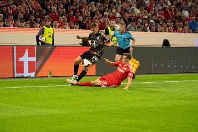 September 18, 2026: Soccer – FC Bayern Munich vs. Union Berlin, Matchday 4 of the Bundesliga at the Allianz Arena in Munich; Josip Stanisic (FC Bayern Munich), No. 44, vs. Michel Aebischer (Union Berlin), 20 IMPORTANT NOTICE: In accordance with the regulations of the DFL and the DFB, it is prohibited to use or allow the use of photographs taken in the stadium and or during the game in the form of sequential images and or video-like photo series. Copyright: xJamesxZabelx