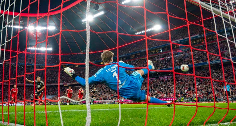 September 18, 2026, 2026–2027 Bundesliga Season, Matchday 4, FC Bayern Munich vs. 1. FC Union Berlin, at the Allianz Arena in Munich, Harry Kane (left) takes a penalty kick for FC Bayern Munich against Union Berlin goalkeeper Frederik Rönnow, making the score 2–0