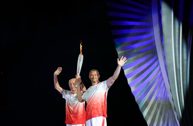(260919) -- NAGOYA, Sept. 19, 2026 -- Murofushi Koji (R) and Murofushi Shigenobu of Japan wave with the torch during the opening ceremony of the 20th Asian Games Aichi-Nagoya 2026 in Nagoya, Japan, Sept. 19, 2026. ) (SP)JAPAN-NAGOYA-ASIAN GAMES-OPENING CEREMONY JiaxHaocheng 