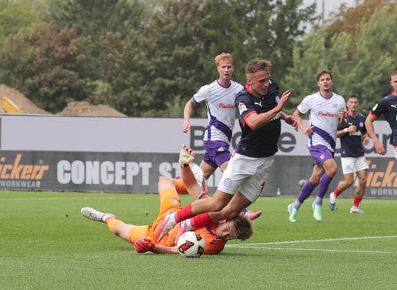 Jonas Krumrey of VfL Osnabrück fouls Phil Harres of Holstein Kiel; penalty kick; soccer; men s; 2026–2027 season; 2. Bundesliga, Holstein Stadium, Holstein Kiel vs. VfL Osnabrück. DFL regulations prohibit any use of photographs as image sequences and or quasi-video.