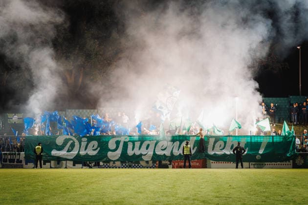 September 18, 2026, xkwix, Soccer, Regionalliga West, SV Rödinghausen vs. FC Gütersloh, Häcker Wiehenstadion, Matchday 9, 2026–2027 season. Pyrotechnic smoke in the visitors’ section. DFB regulations prohibit any use of photographs as image sequences and or quasi-video. Photo: xKamilxWilkowskixPressefotoKochx, North Rhine-Westphalia, Germany