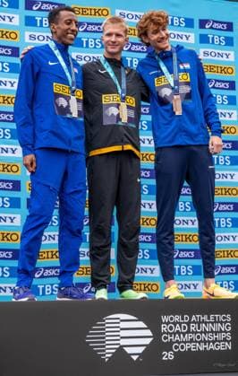 (260919) -- DENMARK, Sept. 19, 2026 -- Gold medalist Robert Farken of Germany (C), silver medalist Yared Nuguse of the United States (L) and bronze medalist Ruben Querinjean of Luxembourg pose during the men s road mile medal ceremony at the World Athletics Road Running Championships in Copenhagen, Denmark, Sept. 19, 2026. (Photo by Xinhua) (SP)DENMARK-COPENHAGEN-WORLD ATHLETICS ROAD RUNNING CHAMPIONSHIPS AndersxKongshaug 