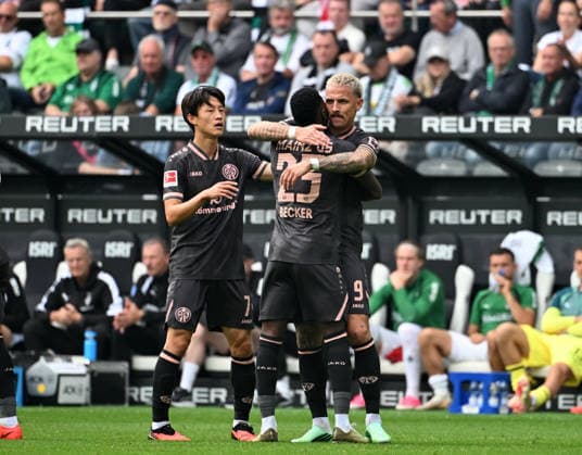 September 19, 2026, Mönchengladbach Soccer, Men s, 2026–2027 Season, Borussia Mönchengladbach vs. 1. FSV Mainz 05: Mainz fans celebrate after the goal that tied the game at 1–1; from left: Jae-sung Lee (Mainz), Sheraldo Becker (Mainz), goal scorer Phillip Tietz (Mainz). DFL regulations prohibit any use of photographs as image sequences and or quasi-video content at Borussia Park, North Rhine-Westphalia, Germany